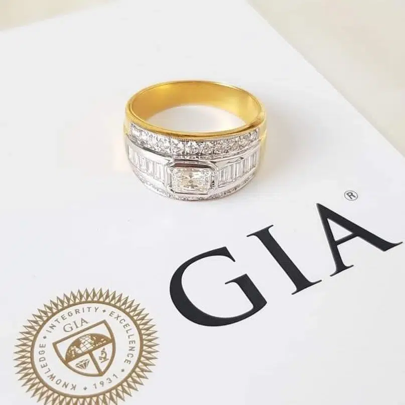 แหวนเพชรตัวเรือนทองวางบนใบรับรองเพชร GIA